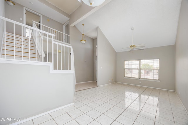 tiled spare room featuring high vaulted ceiling, stairway, ceiling fan, and baseboards