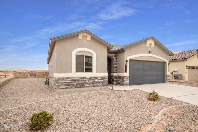 2240 Tierra Delmonte Dr, El Paso, TX 79938 - view of front facade with stucco siding, an attached garage, concrete driveway, and stone siding