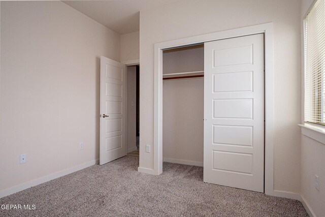 2240 Tierra Delmonte Dr, El Paso, TX 79938 - unfurnished bedroom with light carpet, a closet, and baseboards