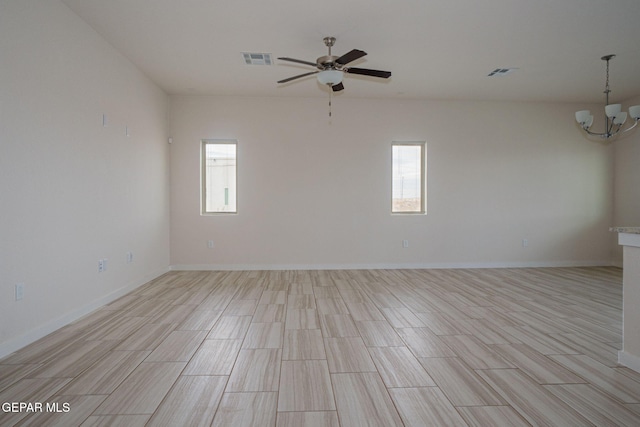2240 Tierra Delmonte Dr, El Paso, TX 79938 - unfurnished room with plenty of natural light, a chandelier, ceiling fan, and light wood-style flooring