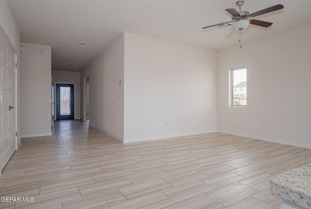 2240 Tierra Delmonte Dr, El Paso, TX 79938 - empty room with light wood finished floors, ceiling fan, and baseboards