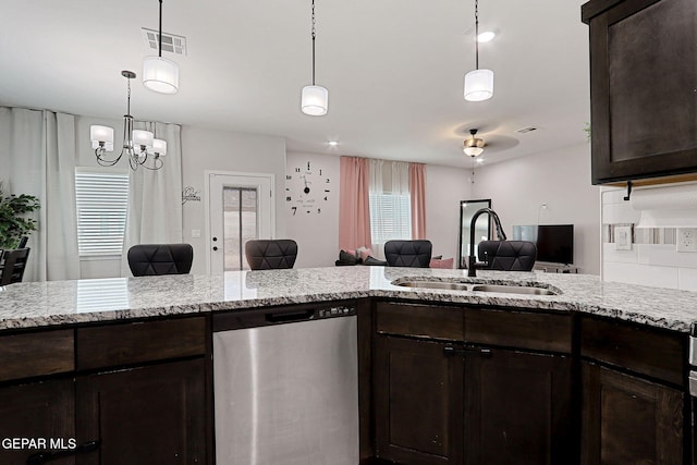 3516 Essence St, El Paso, TX 79938 - kitchen with stainless steel dishwasher, a sink, open floor plan, dark brown cabinetry, and light stone countertops