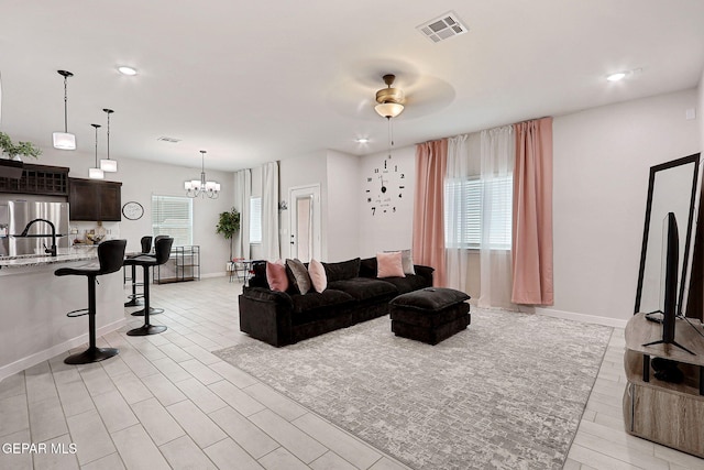 3516 Essence St, El Paso, TX 79938 - living area featuring a chandelier, ceiling fan, baseboards, light wood-style flooring, and recessed lighting