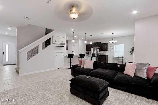 3516 Essence St, El Paso, TX 79938 - living room featuring stairway, ceiling fan, a chandelier, baseboards, and recessed lighting