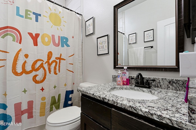 3516 Essence St, El Paso, TX 79938 - full bathroom with toilet, vanity, and a shower with shower curtain