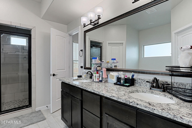 3516 Essence St, El Paso, TX 79938 - full bathroom featuring a shower stall, double vanity, and baseboards