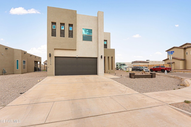3516 Essence St, El Paso, TX 79938 - pueblo revival-style home with a garage, stucco siding, and driveway
