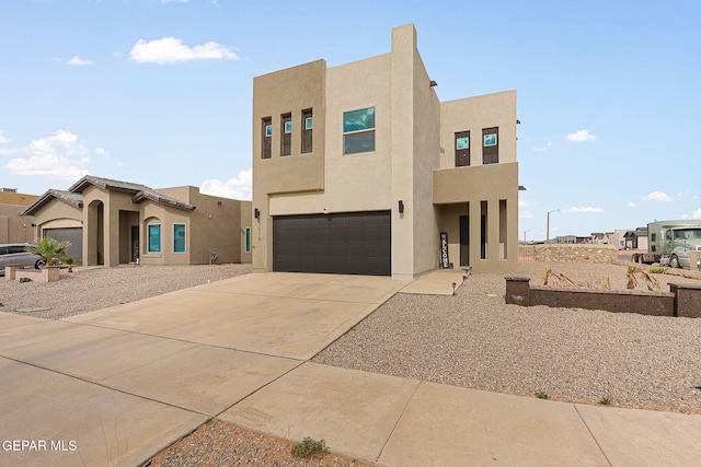 3516 Essence St, El Paso, TX 79938 - view of front of house featuring an attached garage, stucco siding, and driveway