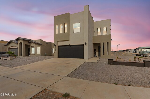 3516 Essence St, El Paso, TX 79938 - view of front of home featuring an attached garage, stucco siding, and concrete driveway