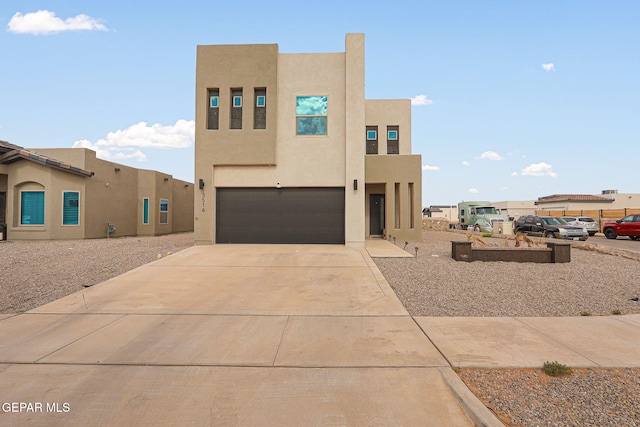 3516 Essence St, El Paso, TX 79938 - adobe home featuring stucco siding, a garage, and driveway