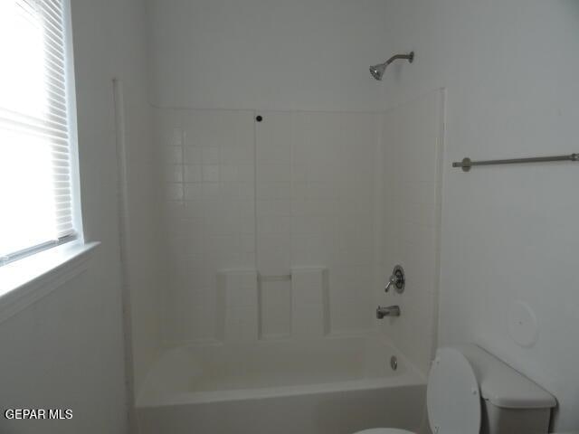 bathroom with toilet and tub / shower combination