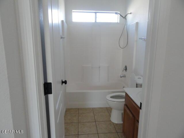 bathroom featuring vanity, toilet, tile patterned flooring, and tub / shower combination
