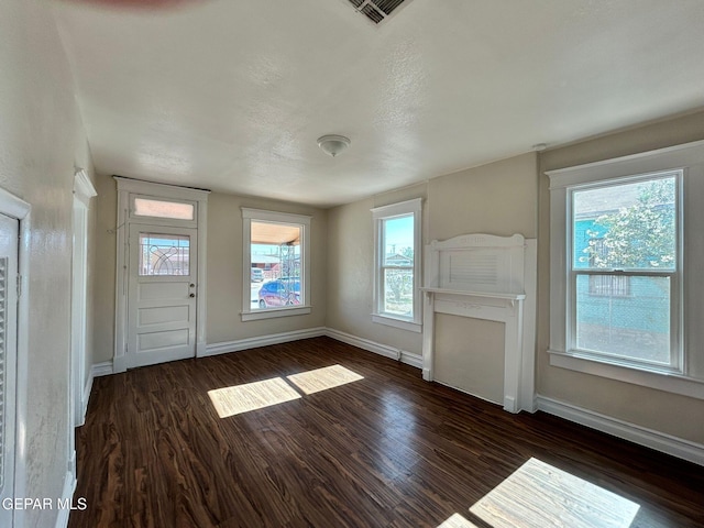 3416 Rivera Ave, El Paso, TX 79905 - unfurnished living room featuring dark wood-style floors and baseboards