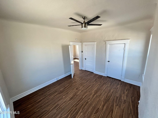 3416 Rivera Ave, El Paso, TX 79905 - unfurnished bedroom with dark wood finished floors, baseboards, and ceiling fan
