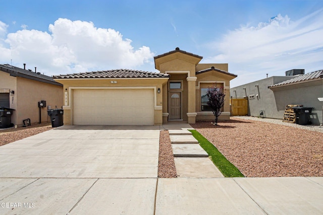 525 Cedarwood Dr, El Paso, TX 79928 - view of front facade featuring a garage, a tiled roof, concrete driveway, and stucco siding
