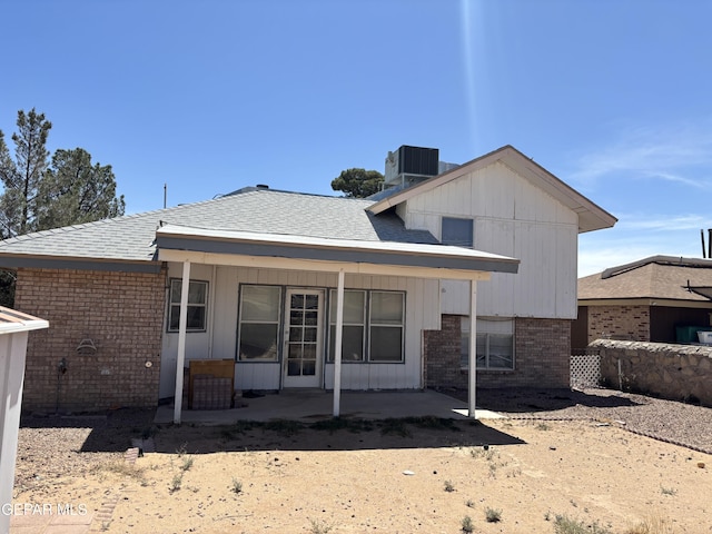 10645 Obsidian St, El Paso, TX 79924 - back of house with brick siding, cooling unit, a patio, and roof with shingles