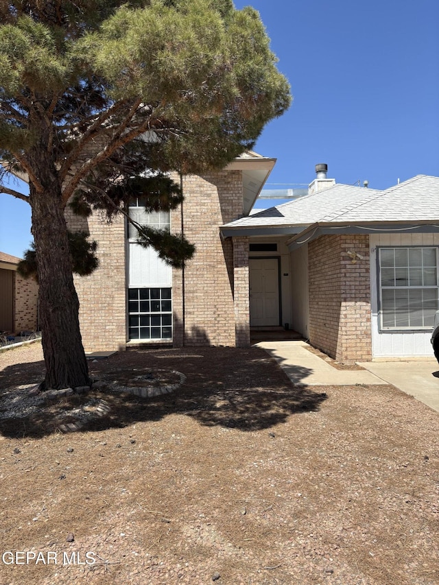 10645 Obsidian St, El Paso, TX 79924 - view of front of home with brick siding and a chimney