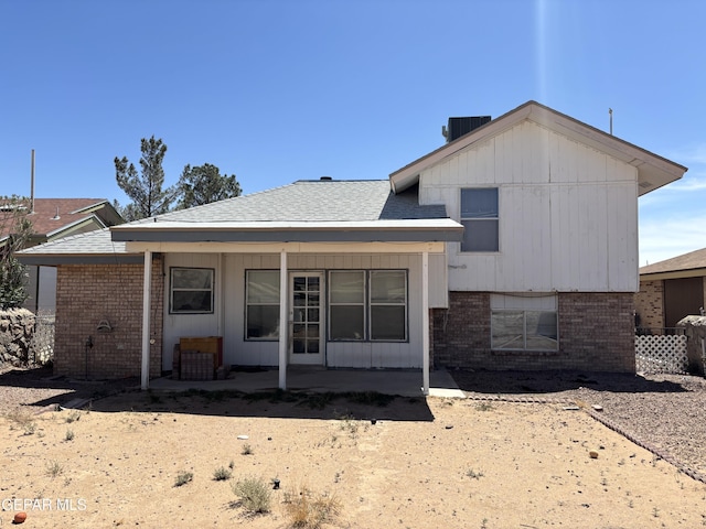 10645 Obsidian St, El Paso, TX 79924 - back of property with brick siding, a patio area, cooling unit, and a shingled roof