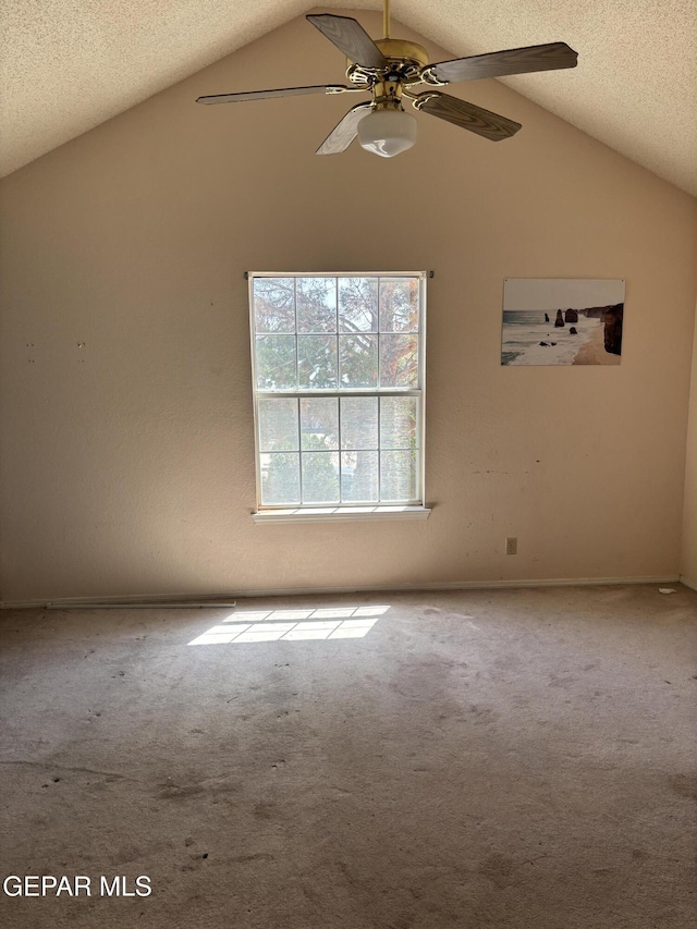 10645 Obsidian St, El Paso, TX 79924 - carpeted spare room featuring vaulted ceiling, ceiling fan, and a textured ceiling