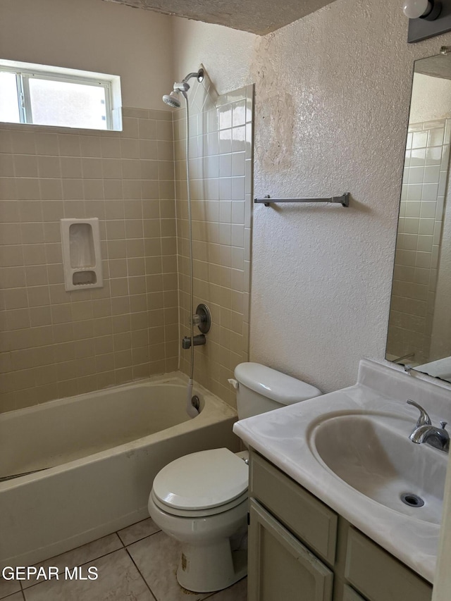 10645 Obsidian St, El Paso, TX 79924 - bathroom with a textured wall, tile patterned flooring, toilet, shower / washtub combination, and vanity