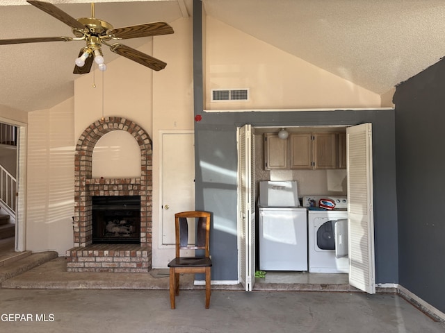 10645 Obsidian St, El Paso, TX 79924 - kitchen featuring washer and dryer, a ceiling fan, concrete floors, a brick fireplace, and a textured ceiling