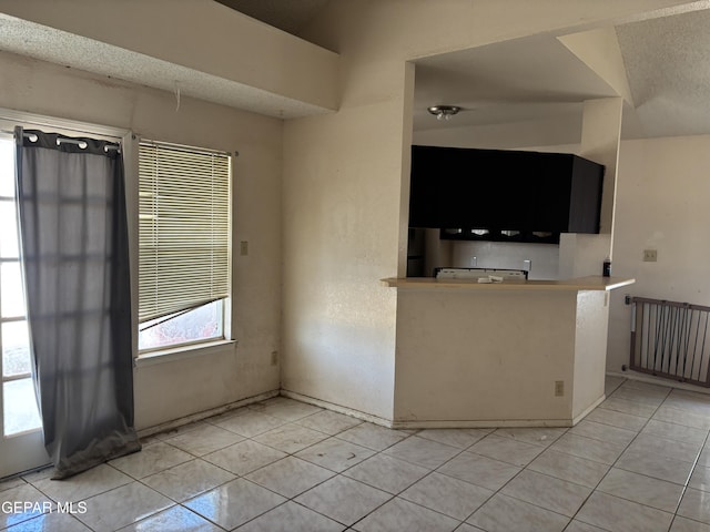 10645 Obsidian St, El Paso, TX 79924 - kitchen with light tile patterned flooring and a textured ceiling