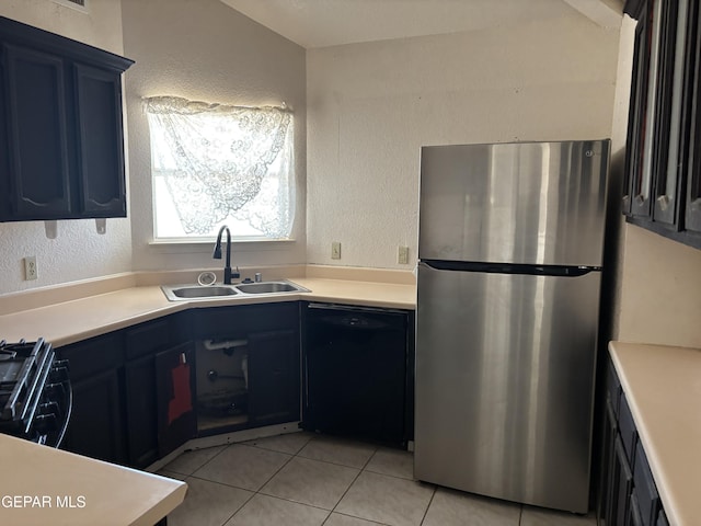 10645 Obsidian St, El Paso, TX 79924 - kitchen featuring freestanding refrigerator, black dishwasher, a sink, light tile patterned floors, and light countertops