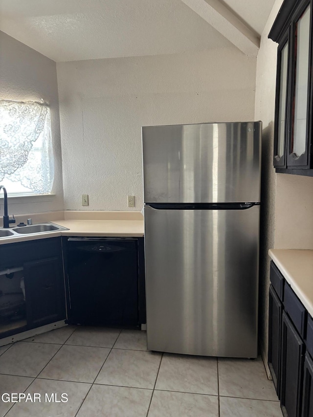10645 Obsidian St, El Paso, TX 79924 - kitchen featuring freestanding refrigerator, dishwasher, a sink, light countertops, and light tile patterned flooring