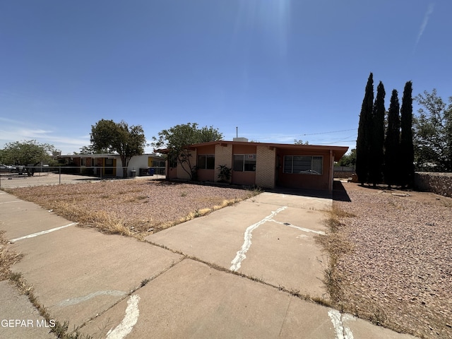 10378 Yellowstone St, El Paso, TX 79924 - view of front of house featuring driveway and brick siding