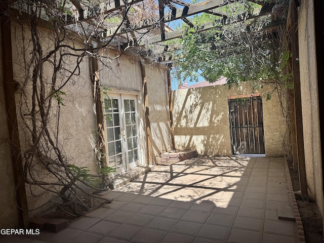 view of patio / terrace featuring french doors and a pergola