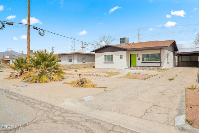 5325 Timberwolf Dr, El Paso, TX 79903 - view of front of house with stucco siding, cooling unit, concrete driveway, and a carport