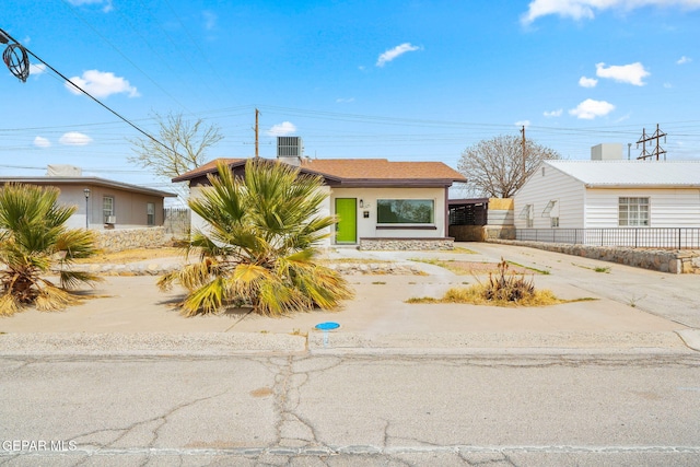 5325 Timberwolf Dr, El Paso, TX 79903 - mid-century modern home featuring concrete driveway, fence, a carport, and stucco siding
