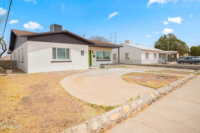 5325 Timberwolf Dr, El Paso, TX 79903 - ranch-style home featuring fence, stucco siding, central AC unit, and curved driveway