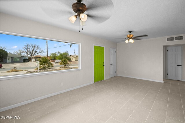 5325 Timberwolf Dr, El Paso, TX 79903 - empty room with ceiling fan, baseboards, and a textured ceiling