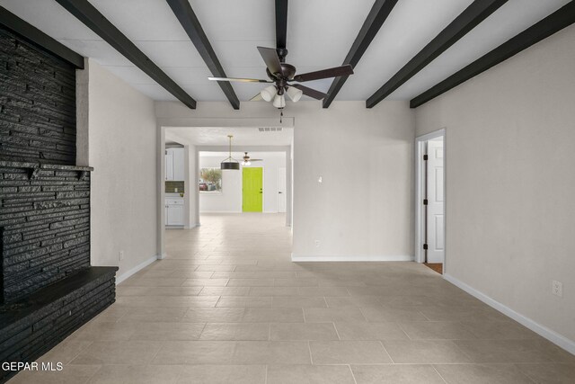 5325 Timberwolf Dr, El Paso, TX 79903 - unfurnished living room with a ceiling fan, beam ceiling, baseboards, and light tile patterned flooring
