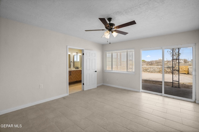5325 Timberwolf Dr, El Paso, TX 79903 - spare room featuring ceiling fan, baseboards, and a textured ceiling