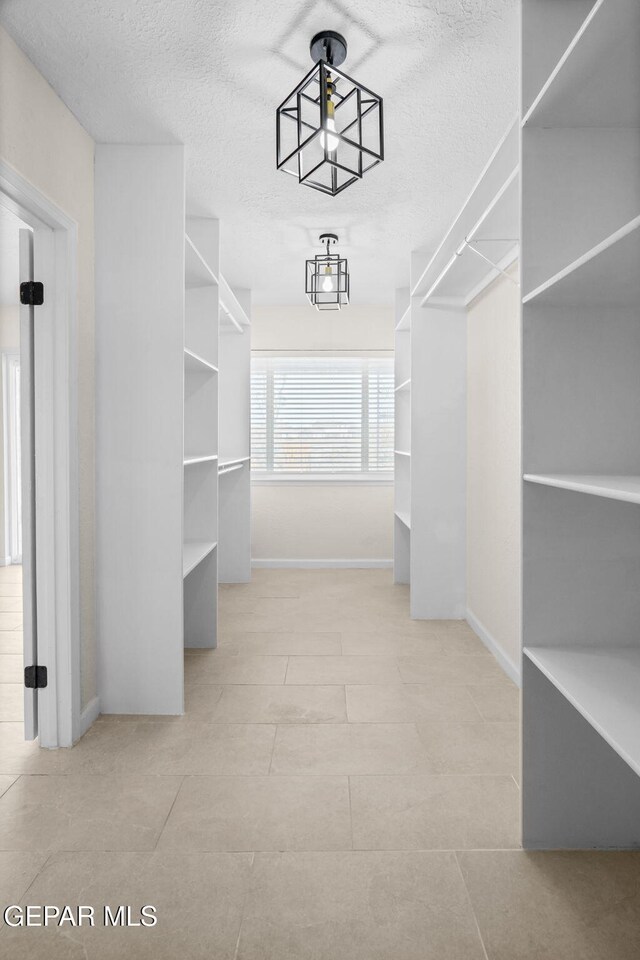 5325 Timberwolf Dr, El Paso, TX 79903 - walk in closet with tile patterned flooring