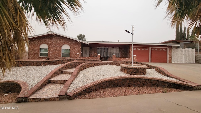 1523 Vista Real Dr, El Paso, TX 79935 - single story home with brick siding, an attached garage, and concrete driveway
