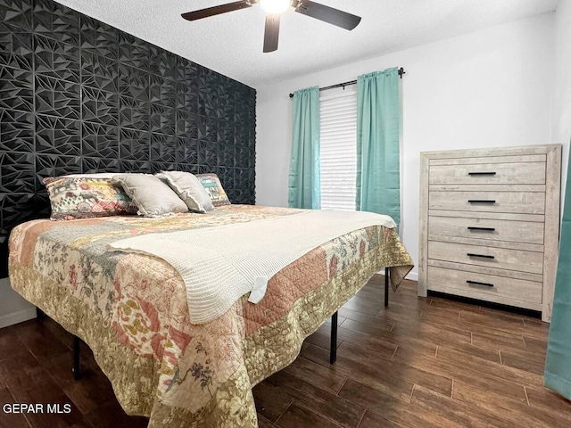 1523 Vista Real Dr, El Paso, TX 79935 - bedroom with wood finished floors, a ceiling fan, a textured ceiling, and an accent wall