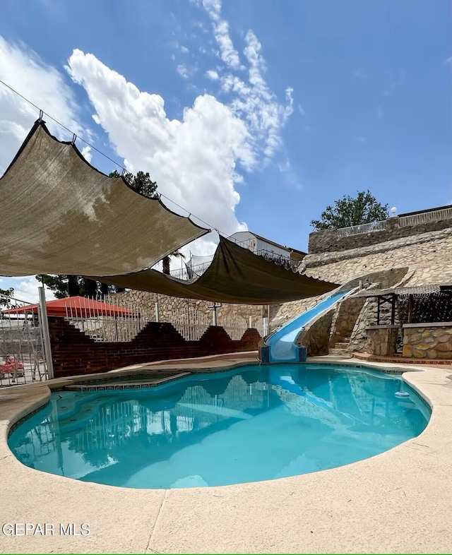 1523 Vista Real Dr, El Paso, TX 79935 - view of pool with a water slide and a fenced backyard