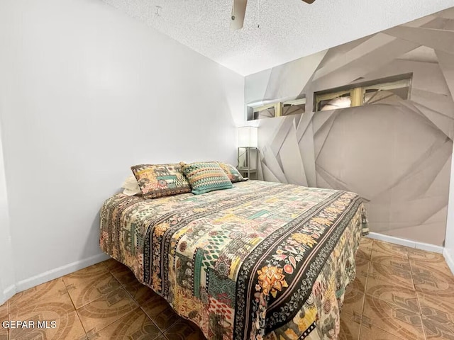 1523 Vista Real Dr, El Paso, TX 79935 - tiled bedroom featuring a textured ceiling, baseboards, and a ceiling fan
