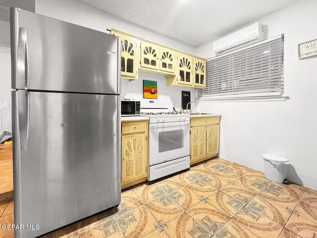 1523 Vista Real Dr, El Paso, TX 79935 - kitchen with freestanding refrigerator, white gas range, a wall mounted AC, light countertops, and a sink