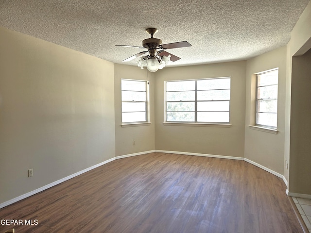 unfurnished room featuring wood finished floors, a ceiling fan, a textured ceiling, and baseboards