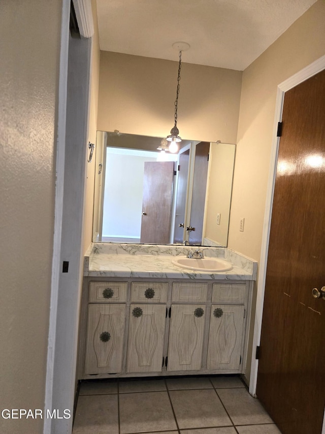 bathroom with tile patterned floors and vanity