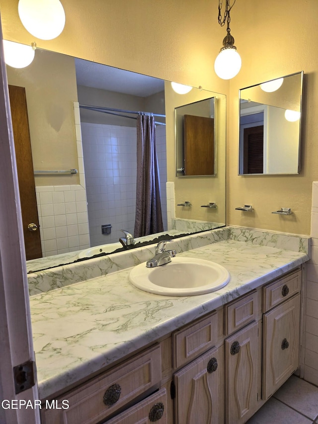 bathroom featuring vanity, curtained shower, and tile patterned flooring