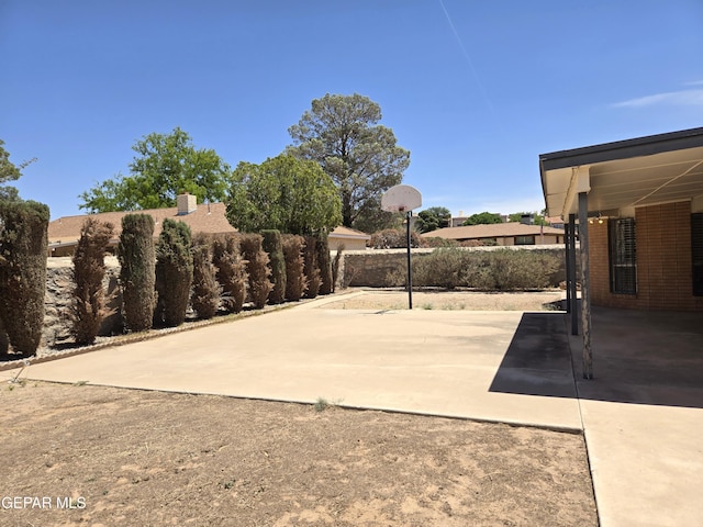 view of patio / terrace featuring fence and a carport