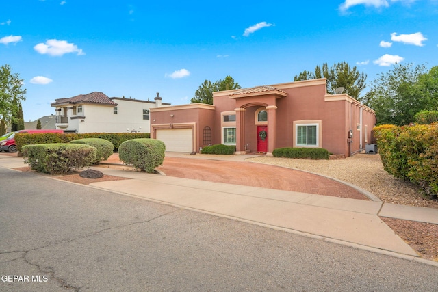 421 Wild Willow Dr, El Paso, TX 79922 - mediterranean / spanish-style home featuring an attached garage, concrete driveway, stucco siding, and a tile roof
