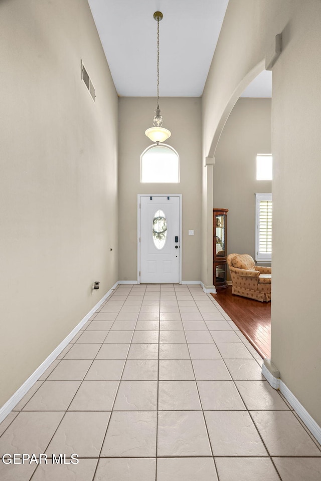 421 Wild Willow Dr, El Paso, TX 79922 - foyer entrance featuring arched walkways, a towering ceiling, and light tile patterned flooring