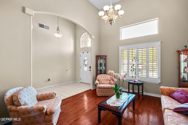 421 Wild Willow Dr, El Paso, TX 79922 - living room featuring high vaulted ceiling, a chandelier, wood-type flooring, arched walkways, and baseboards