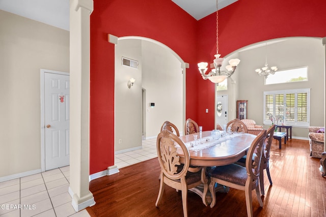 421 Wild Willow Dr, El Paso, TX 79922 - dining room with high vaulted ceiling, a chandelier, hardwood / wood-style floors, ornate columns, and baseboards